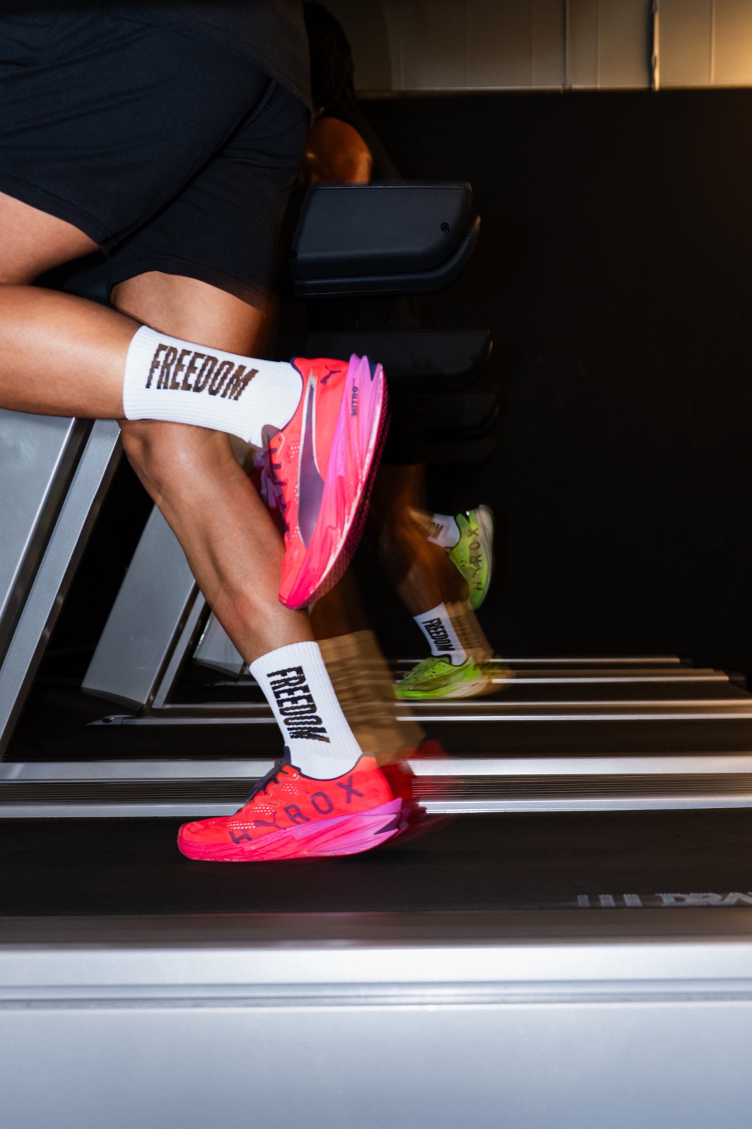 Treadmill close-up — FREEDOM socks and HYROX shoes captured with motion blur